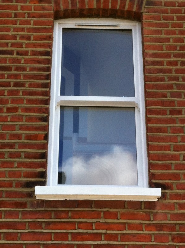 uPVC sash window on Victorian red brick house in Croydon